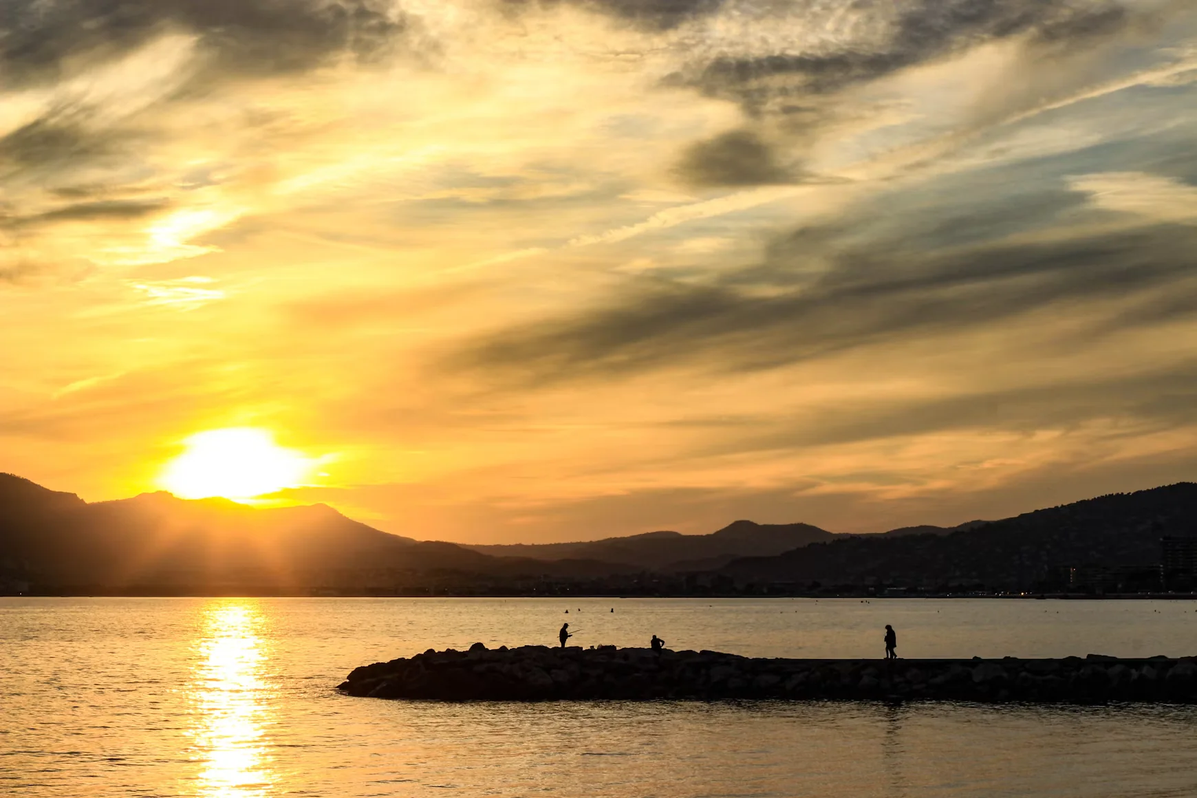 The sun setting behind the Esterel mountains, seen from Cannes