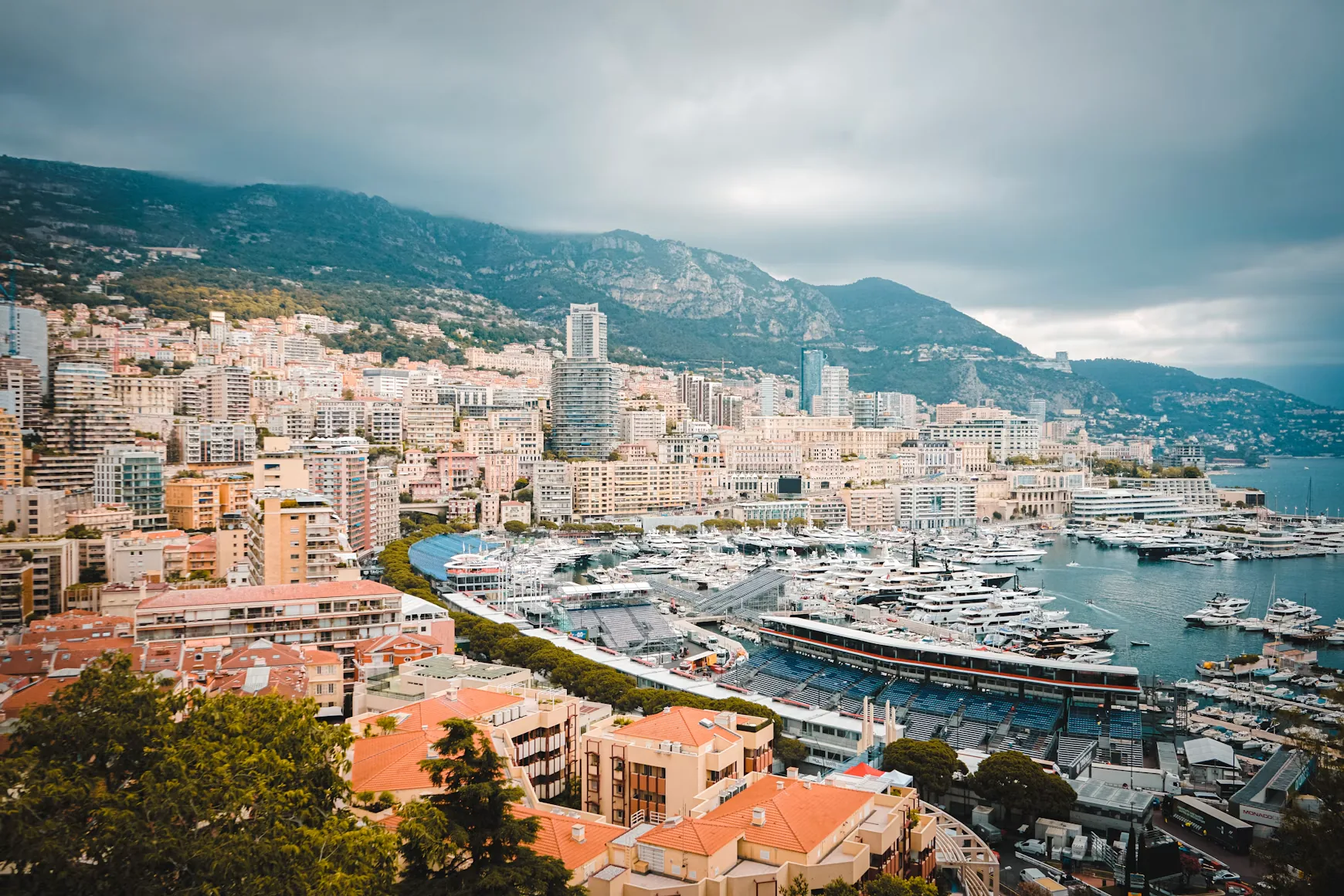 Monaco harbour full of yachts below the mountains