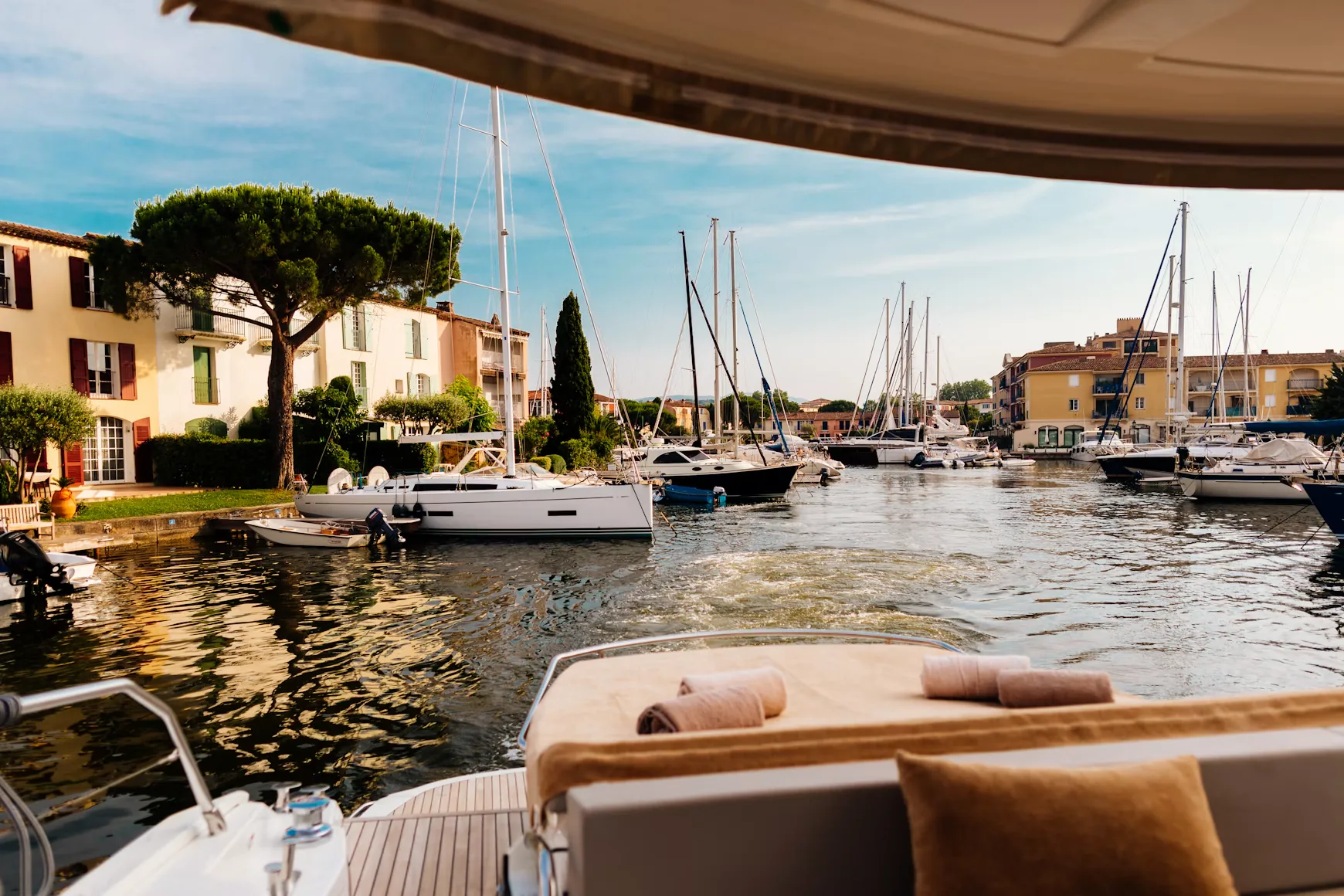 View from a yacht deck of a harbour with sailboats